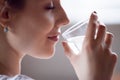 Close up of thirsty pretty female enjoying pure water Royalty Free Stock Photo