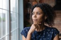 Close up thoughtful African American woman looking out window Royalty Free Stock Photo