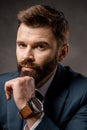 close up of thoughtful bearded businessman with watch