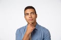 Close-up thoughtful brazilian man, rubbing chin and looking up, pondering idea, have some plan, thinking or making Royalty Free Stock Photo