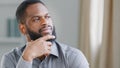 Close up thoughtful pensive ethnic bearded African American man thinking businessman worker searching solution boss