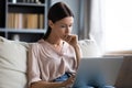 Close up thoughtful upset woman looking at laptop screen