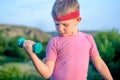 Close up Thoughtful Young Boy Lifting Dumbbell Royalty Free Stock Photo