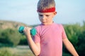 Close up Thoughtful Young Boy Lifting Dumbbell Royalty Free Stock Photo