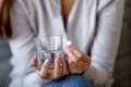 Close up of hesitant woman doubting to take pill