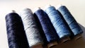 Close-up of threads in different shades of blue. Spools of thread located on a white background. Hard light Royalty Free Stock Photo