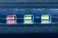 Close-up of three brightly colored magnets placed together in a desk drawer