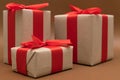 Close-up brown paper gift box red bow ribbon brown background. concept for happy love gift Royalty Free Stock Photo