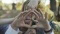 Close-up of three Caucasian hippies making peace sign with hands. Positive men and women expressing love and pacifism