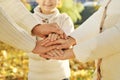 Close up of three Caucasian person stack their palms. Father, mother and son holding their hands together. Gesture sign