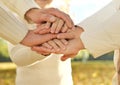 Close up of three Caucasian person stack their palms. Father, mother and son holding their hands together. Gesture sign