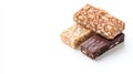 Colorful cereal bars featuring chocolate, peanuts, and puffed rice, arranged neatly on pristine white surface, representing Royalty Free Stock Photo