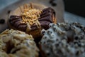 Close-up of Three doughnuts covered with Choco peanut butter, Cookies and creme and Almendras Royalty Free Stock Photo