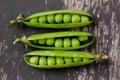 Close up of three English pea pods