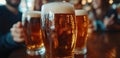 Close-up of three glasses of beer on a table in a pub, with blurred friends in the background Royalty Free Stock Photo