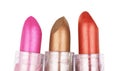 Close up of three lipsticks in different colors isolated on whit