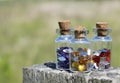 Close up of three little glass bottles each with different colored beads. Royalty Free Stock Photo