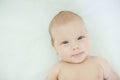 Close-up of three months old baby girl with blue eyes. Newborn child, little adorable smiling girl looking at camera