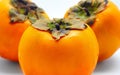 Close up of three persimmons isolated on white background