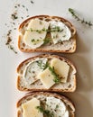A close up of three pieces of bread covered in cheese and herbs. Royalty Free Stock Photo