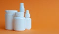 Close-up of three portable plastic bottles with tablets and vitamins and one transparent plastic bottle with a disinfectant