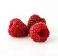Close-up of three raspberry berries on white background. Royalty Free Stock Photo