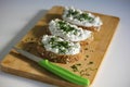 Close-up of three slices of wholemeal bread spread with butter and cottage cheese with chives Royalty Free Stock Photo