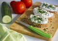 Close-up of three slices of wholemeal bread spread with butter and cottage cheese with chives Royalty Free Stock Photo