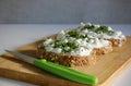 Close-up of three slices of wholemeal bread spread with butter and cottage cheese with chives Royalty Free Stock Photo