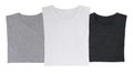 Close-up of the three t-shirts (black, white and grey). Royalty Free Stock Photo