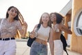 Close up of three teenage girls in casual clothes drinking tasty lemonade on the go Royalty Free Stock Photo