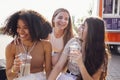 Close up of three teenage girls in casual clothes drinking tasty lemonade on the go Royalty Free Stock Photo