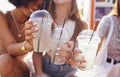 Close up of three teenage girls in casual clothes drinking tasty lemonade on the go Royalty Free Stock Photo