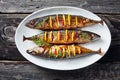 Close-up of three whole broiled hot mackerel