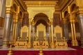 close-up of throne room, with the royal family sitting on their thrones