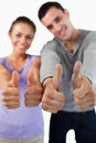 Close up of thumbs up being given by young couple