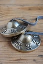 Close-up of Tibetan cymbals on wooden table, Royalty Free Stock Photo