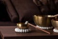 A close up of a tibetan singing bowl or himalayan bowl, with a mallet leaning on the side of it to make a relaxing sound. The