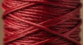 Close-up of tightly wound red twine, displaying its intricate texture and fibrous