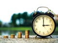 Close up of time and stack money coins, time value of money concept in business finance theme. Saving money for future