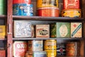 Close-up of tins of vintage dry goods on wooden shelves in general store