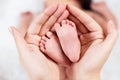 Close-up tiny baby feet in hands. Royalty Free Stock Photo