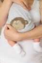 Close-up of tiny baby in socks in the hands of his mother. Young mom hugging her newborn child. Motherhood and childhood. New life Royalty Free Stock Photo