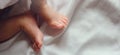 Close-up tiny newborn baby feet on a white blanket Royalty Free Stock Photo