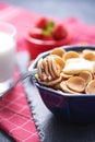 Close up tiny pancakes cereals on fork against blue bowl of pancakes Royalty Free Stock Photo