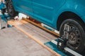 Close-up of a tire clamped by a leveler that passes the automatic alignment of the wheels in the garage, garage and
