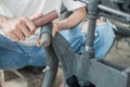 Close up of a tire repairer`s hand rubbing a leaky inner tube