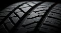 Close-up of a tire tread, highlighting its detailed pattern and texture. The rubber Royalty Free Stock Photo