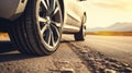 Close up tire and wheel of a car on the road in background. The driving concept of travel and vacation Royalty Free Stock Photo