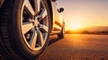 Close up tire and wheel of a car on the road in background. The driving concept of travel and vacation Royalty Free Stock Photo